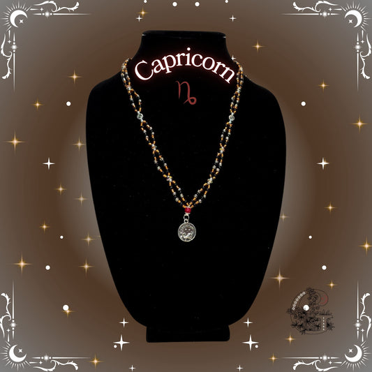 Capricorn Zodiac Necklace – handcrafted beaded necklace in brown and gold tones with the Capricorn symbol, symbolizing focus and ambition.
