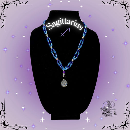 Sagittarius Zodiac Necklace – handcrafted beaded necklace in purple tones featuring the Sagittarius symbol, representing adventure and optimism.